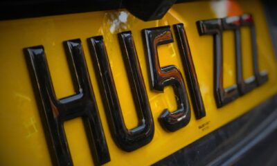 A close-up of the word HU5I ZZZ on a 4D license plates