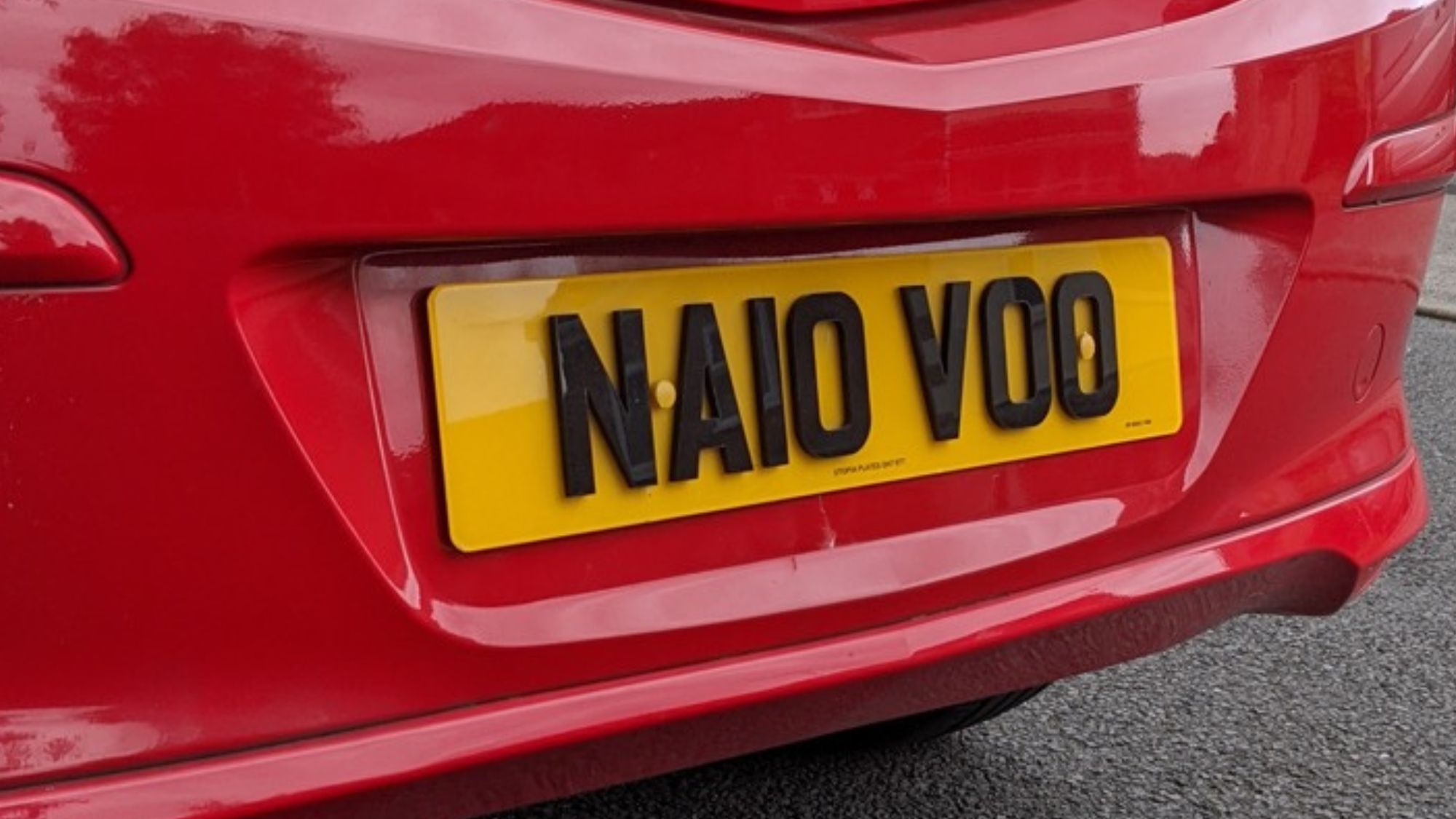 A red car with 4d license plates help to improve vehicle identification